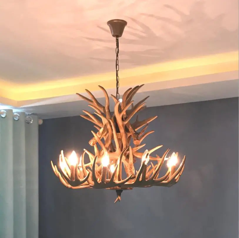 Antler-style chandelier hanging in a room with a neutral background