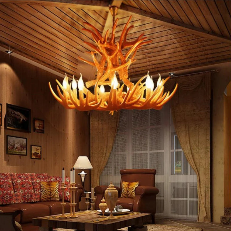 Decorative chandelier hanging in a living room with wooden ceiling and furniture.