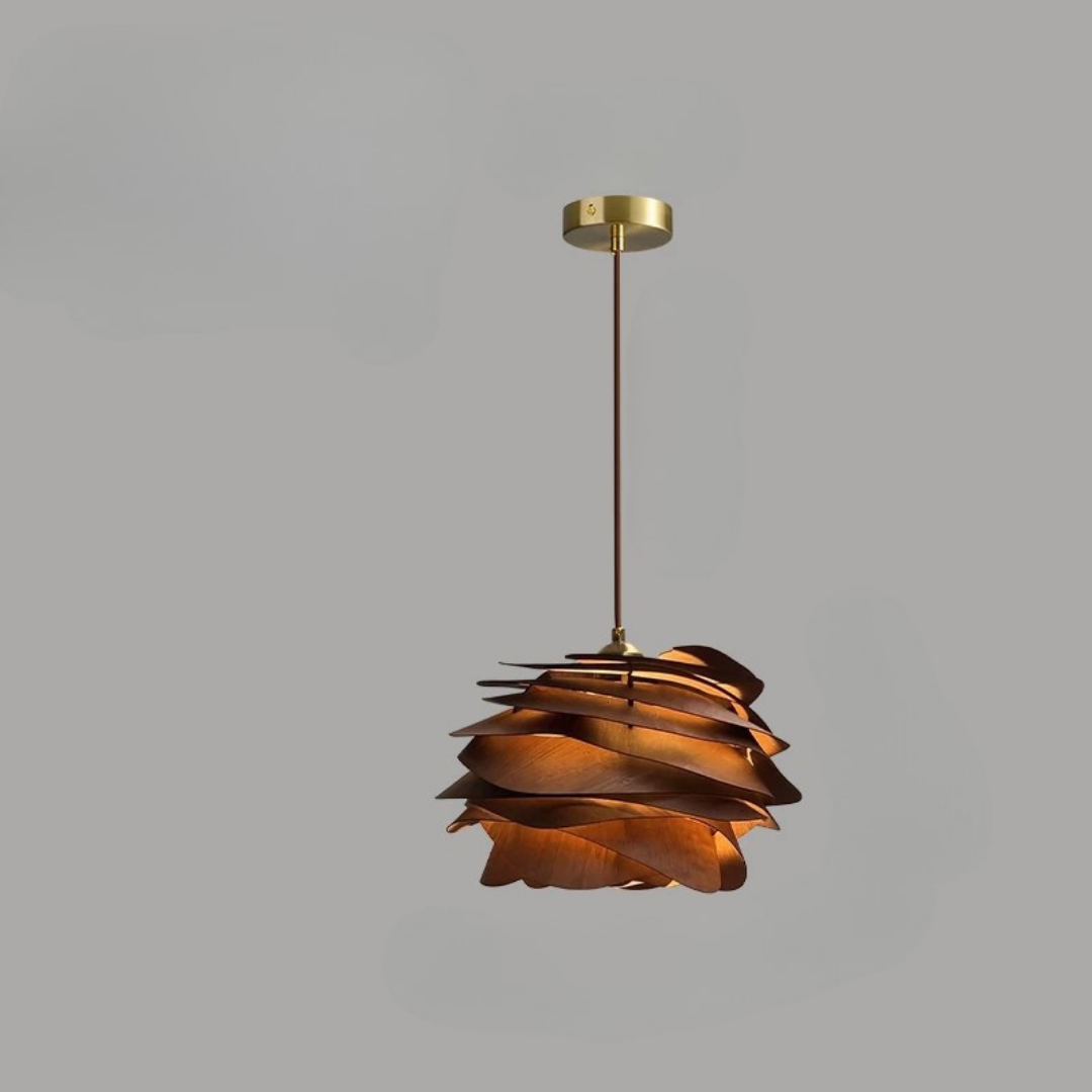Decorative pendant light with a gold finish on a gray background