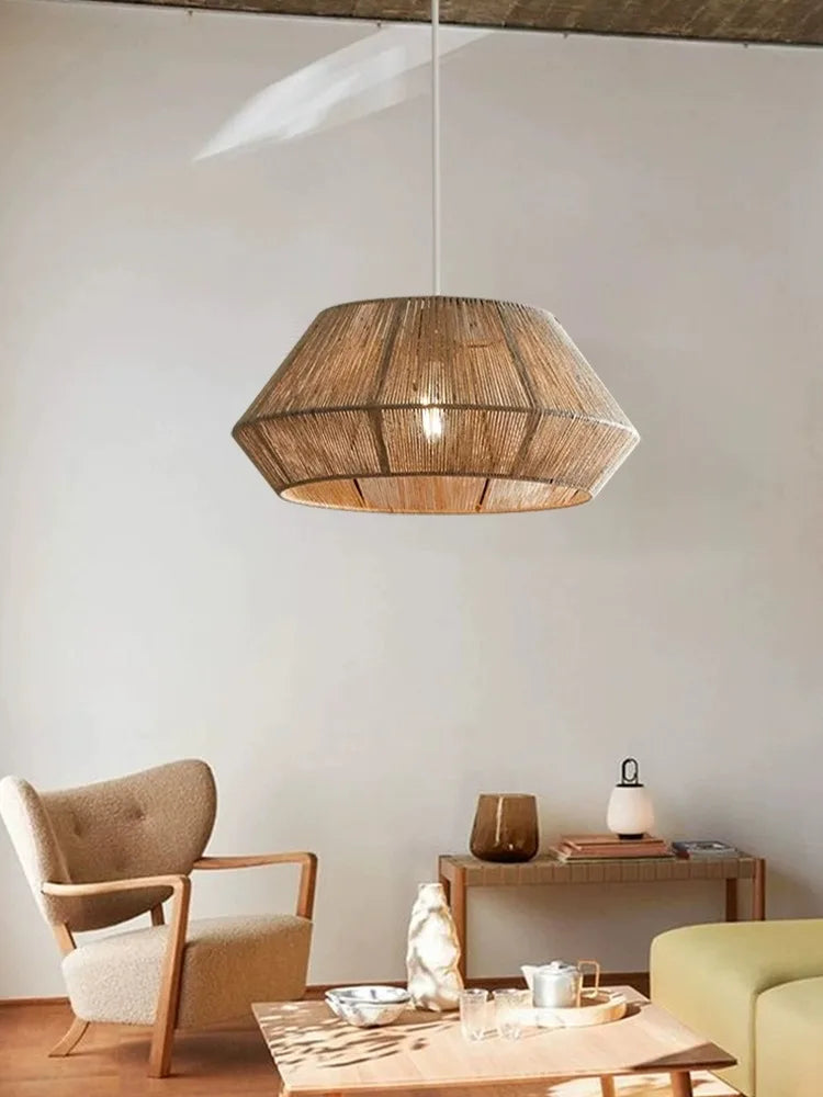 Modern living room with a geometric wooden pendant light, armchair, and coffee table.