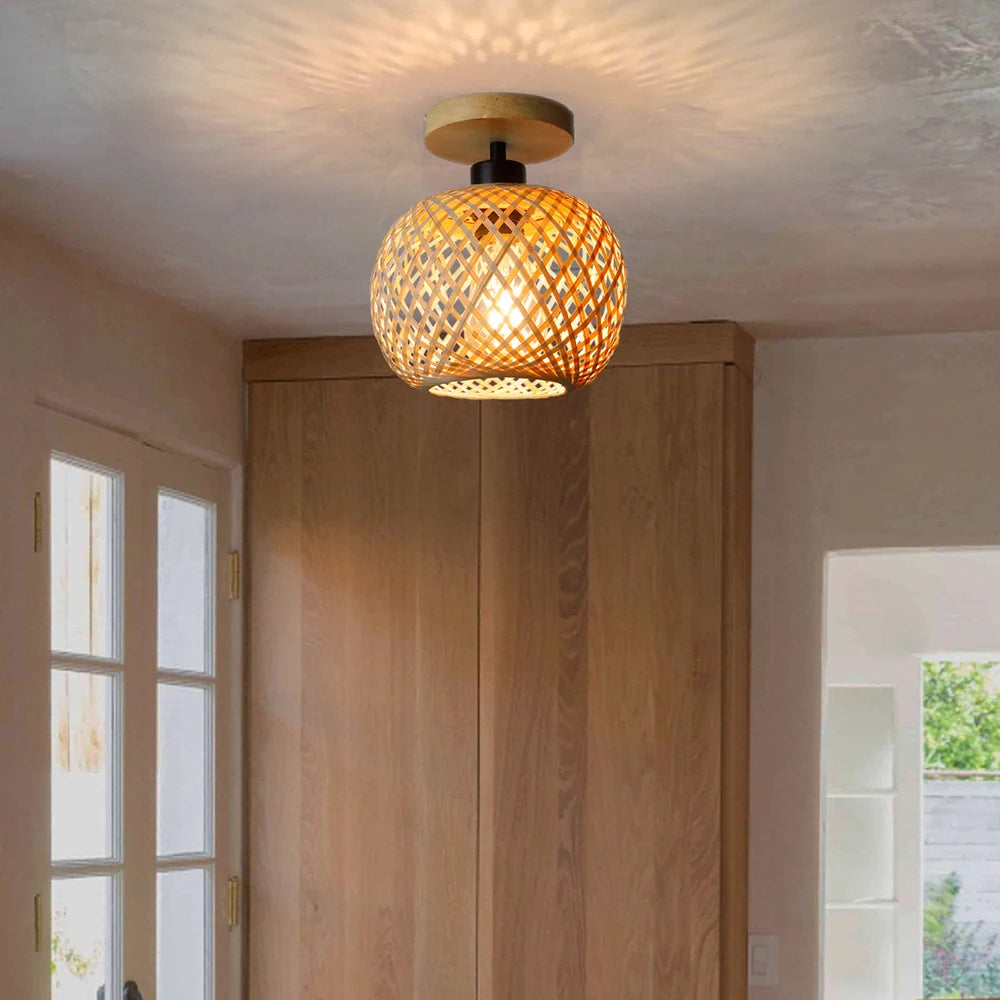 Ceiling light fixture with a decorative glass shade in a room with wooden doors and windows.