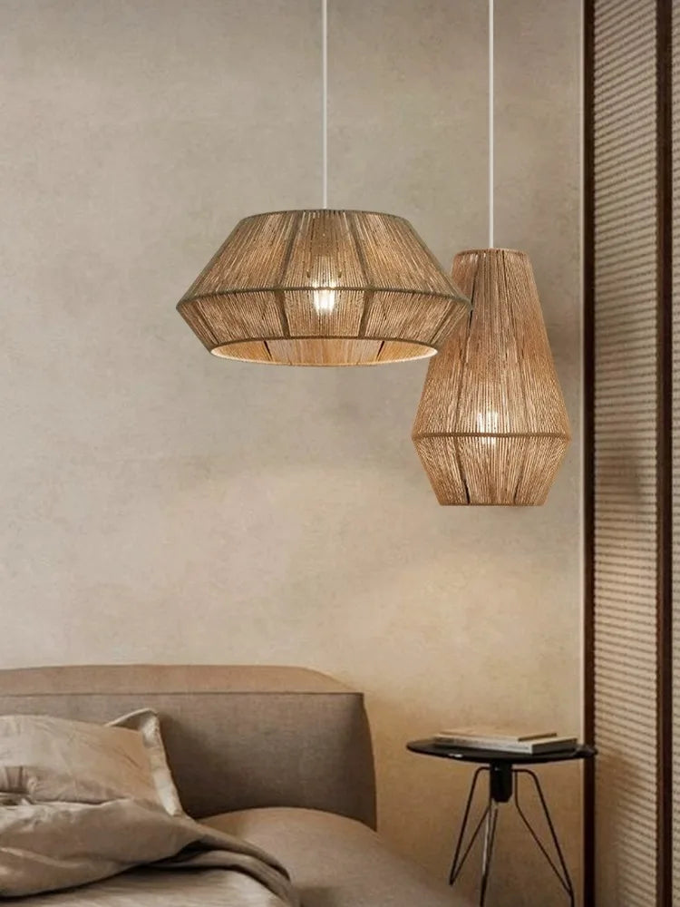 Two woven pendant lights hanging above a bed in a bedroom setting.