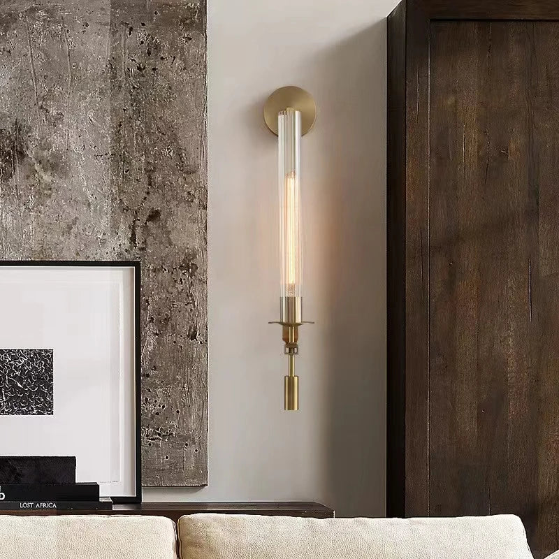 Vertical brass wall lamp with minimalist design and glass tube