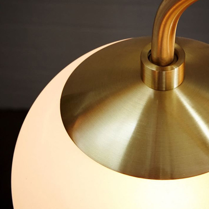 minimalist globe light fixture with brass finish