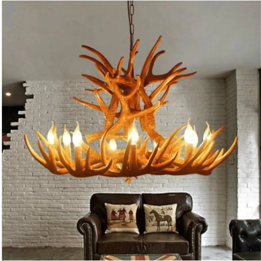 Antler-style chandelier hanging above a sofa with decorative pillows in a room with white brick walls.