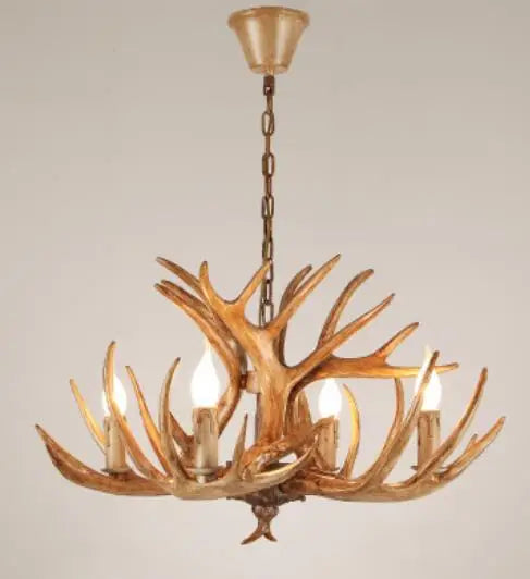 Antler chandelier with three light bulbs on a plain background