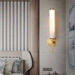 Contemporary wall sconce with frosted diffuser and sleek metal accents