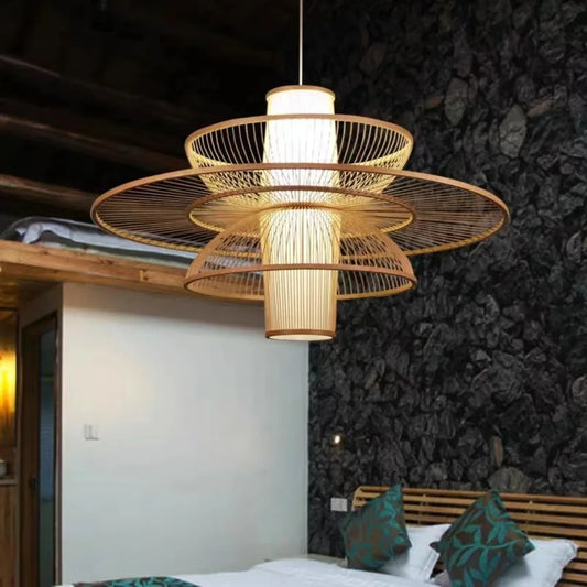 Decorative ceiling light fixture in a room with a bed and dark wall.