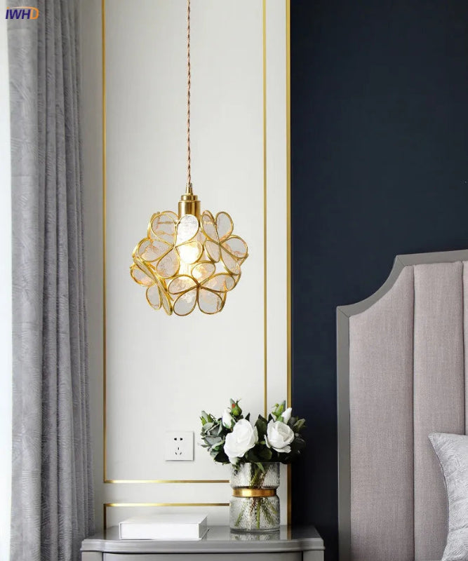 Decorative pendant light fixture in a bedroom setting with a floral design.