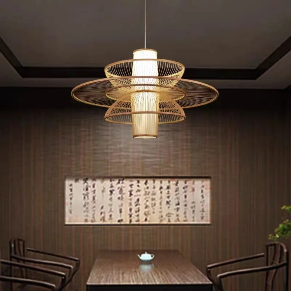Decorative pendant light hanging above a table in a room with wooden walls and a painting.