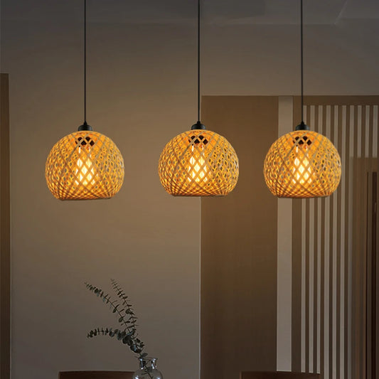 Handmade woven bamboo pendant lights with warm glow hanging above dining table