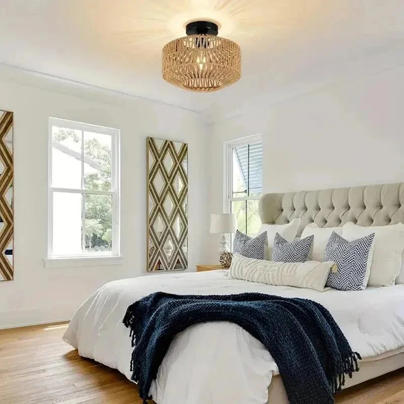 Modern bedroom with a bed, decorative pillows, and a ceiling light fixture.