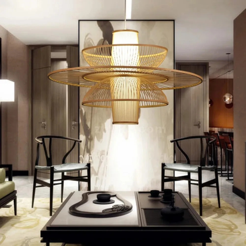 Modern interior design with a large gold chandelier, chairs, and a table.