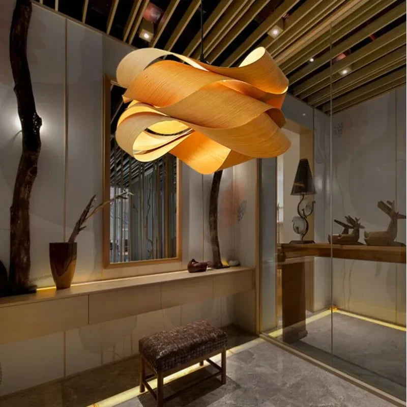 Modern interior design with a large orange pendant light, mirror, and decorative elements.