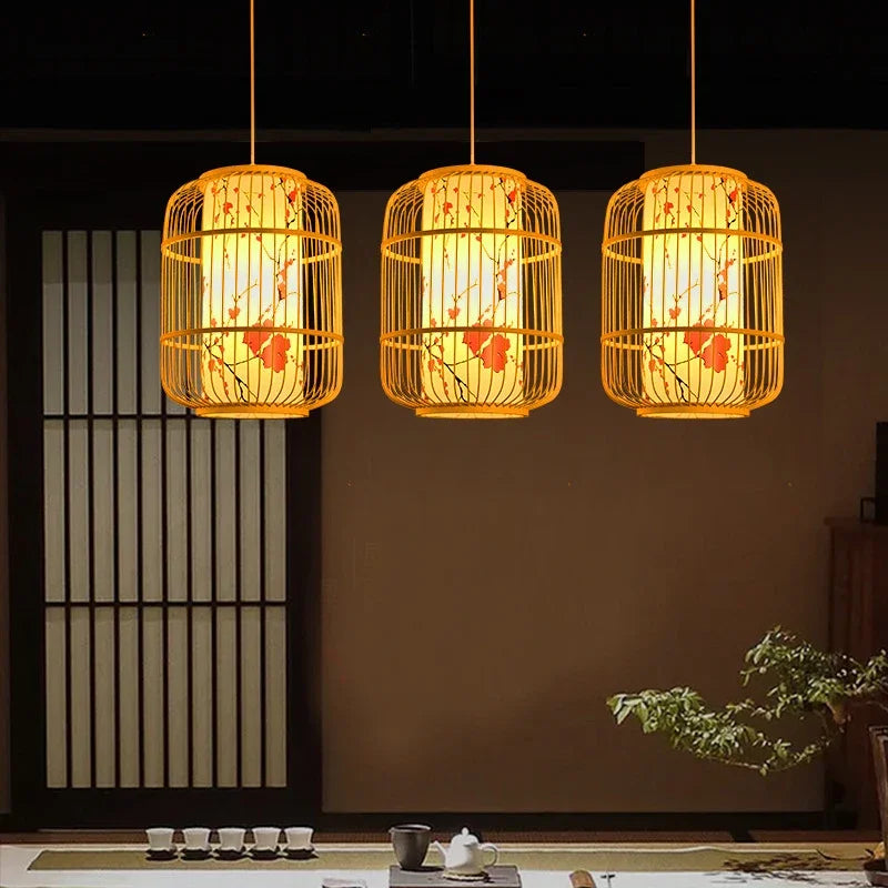 Three illuminated rattan pendant lights hanging in a room with a dark wall and minimal decor.