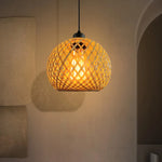 Woven pendant light hanging against a neutral wall