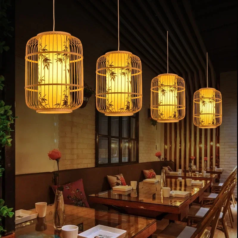 Woven pendant lights hanging above a restaurant table setting.