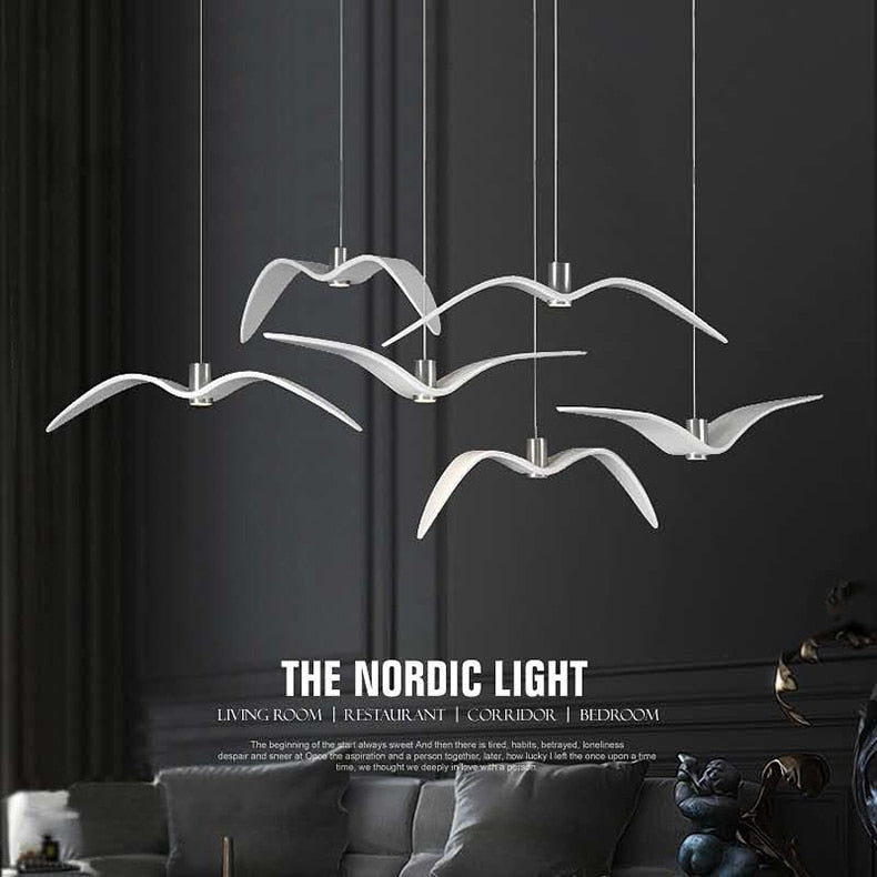 Bird wing chandelier illuminated in dark interior