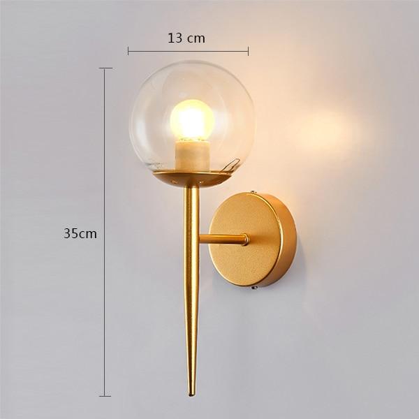 clear glass globe wall sconce gold