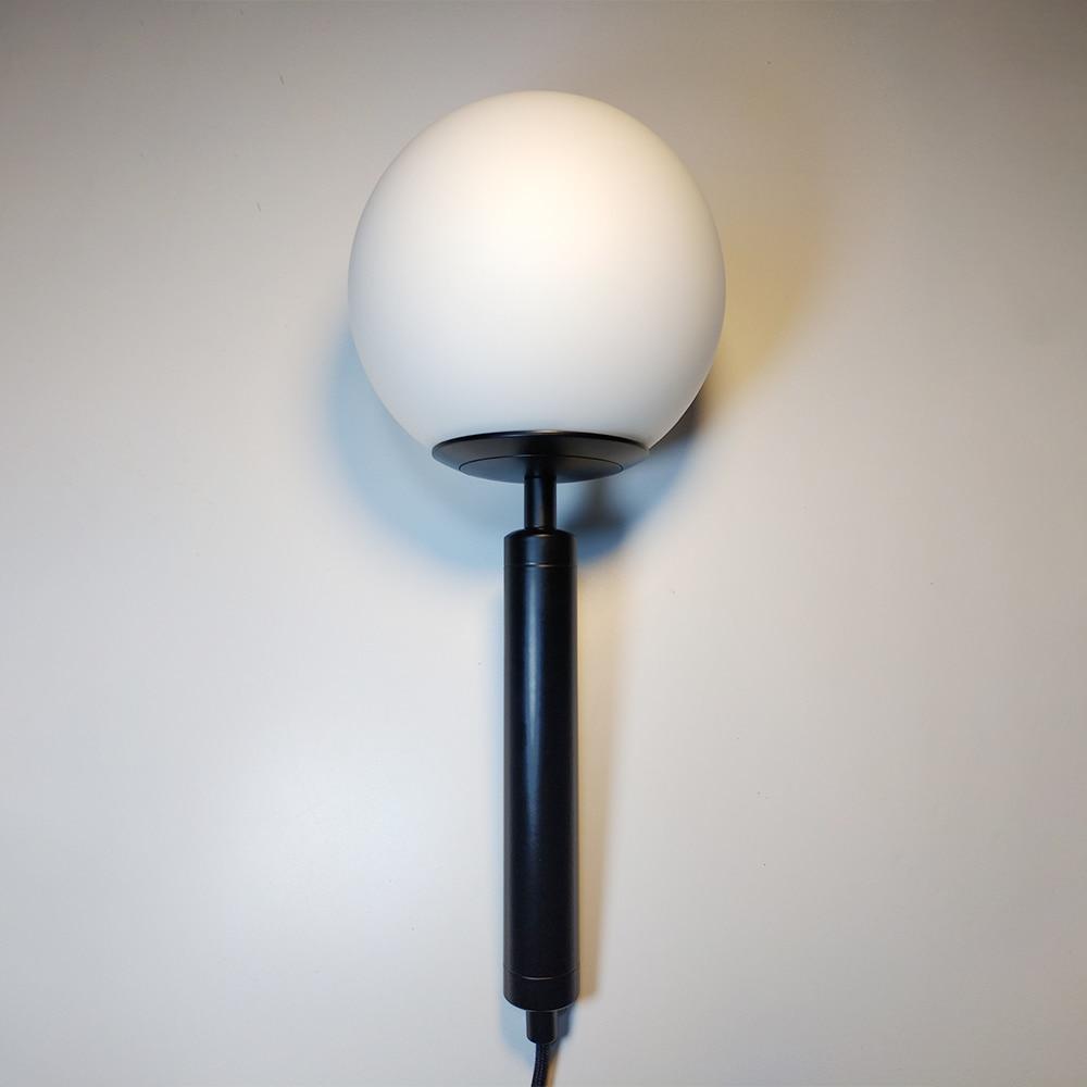 frosted globe wall sconce black