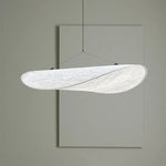 Soft-glow Tense Tyvek Pendant Lamp in a cozy bedroom