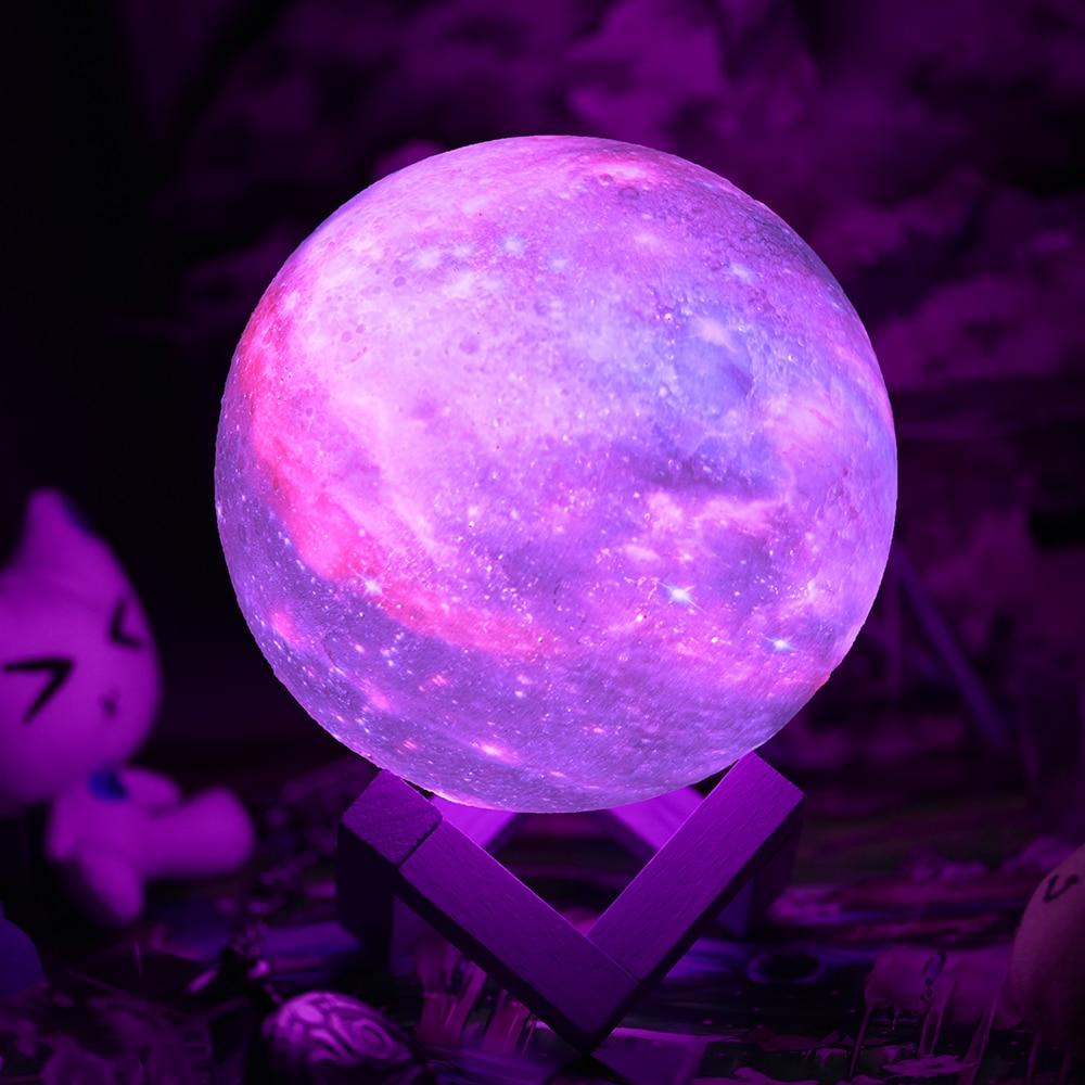 Color-changing LED moon night light on wooden table