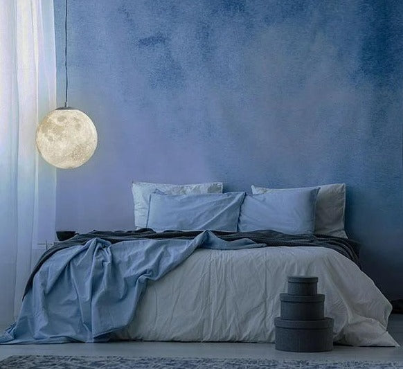 Hanging moon light lamp glowing above cozy bedroom